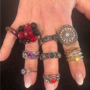 9 silvertone costume rings(4 stretchy) in many colors and shapes.